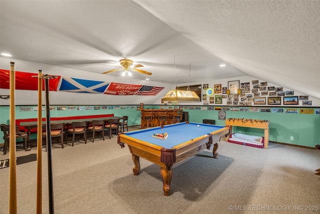 recreation room with lofted ceiling, bar, carpet flooring, and a textured ceiling