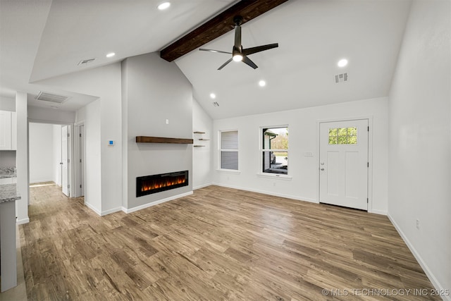 unfurnished living room with beamed ceiling, hardwood / wood-style flooring, high vaulted ceiling, and ceiling fan