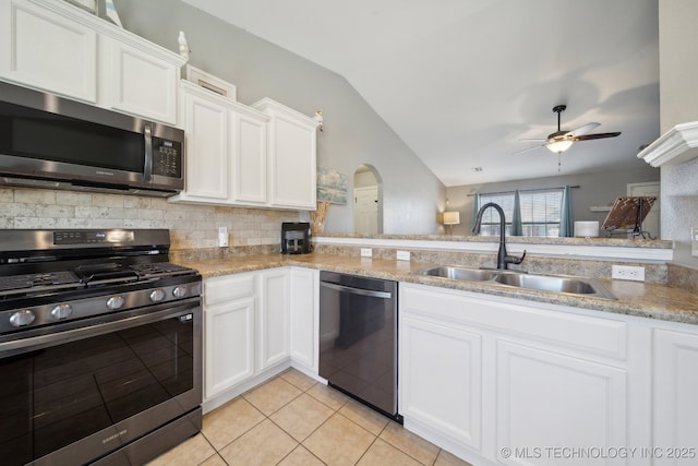 kitchen featuring white cabinetry, sink, lofted ceiling, and stainless steel appliances