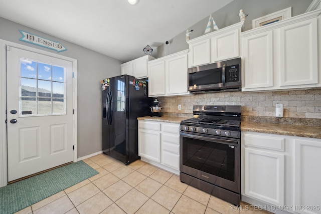 kitchen with tasteful backsplash, white cabinetry, light tile patterned flooring, and appliances with stainless steel finishes