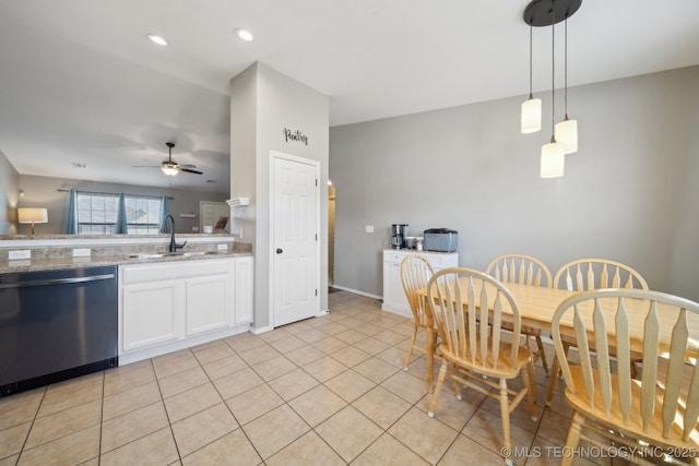 kitchen featuring dishwashing machine, ceiling fan, sink, white cabinets, and hanging light fixtures