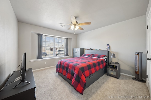 bedroom with ceiling fan and light carpet