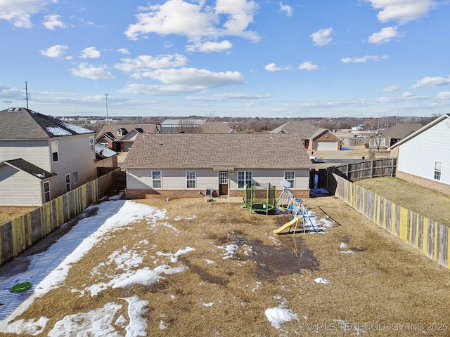 rear view of house with a playground