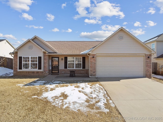 ranch-style house featuring brick siding, a shingled roof, fence, a garage, and driveway