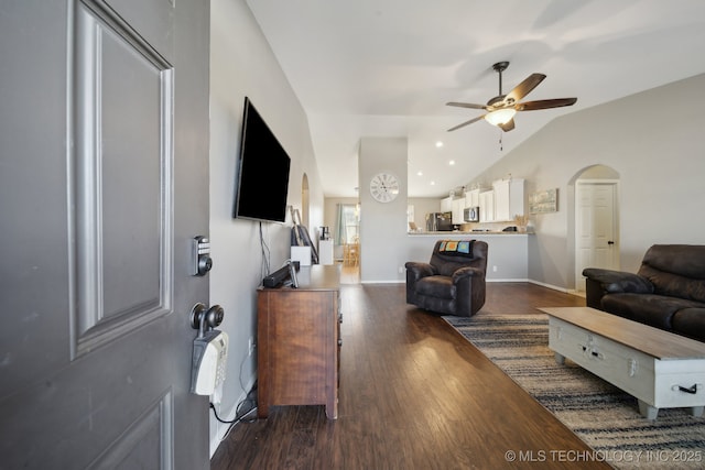 living room with dark hardwood / wood-style flooring, ceiling fan, and lofted ceiling