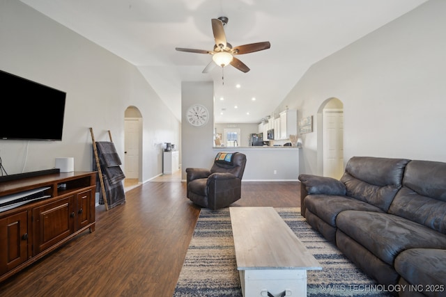 living room with dark hardwood / wood-style floors, ceiling fan, and lofted ceiling