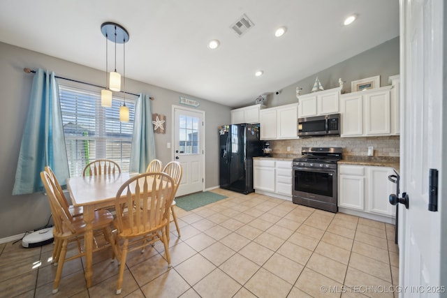 kitchen featuring white cabinets, pendant lighting, light tile patterned floors, and appliances with stainless steel finishes