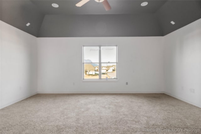 carpeted empty room with lofted ceiling and ceiling fan