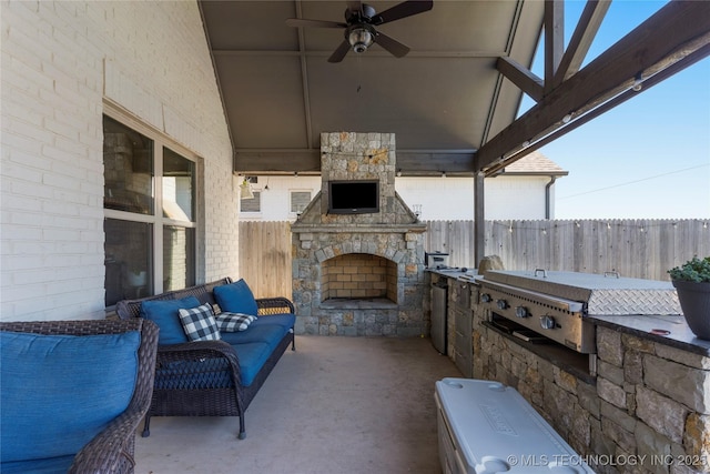 view of patio / terrace with area for grilling, grilling area, ceiling fan, and an outdoor stone fireplace