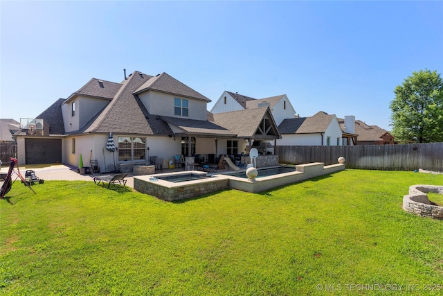 back of property with a lawn, an in ground hot tub, and a patio