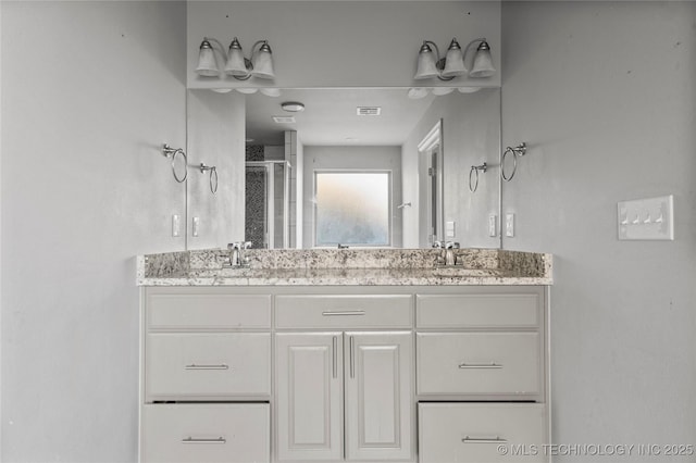 bathroom with an enclosed shower and vanity