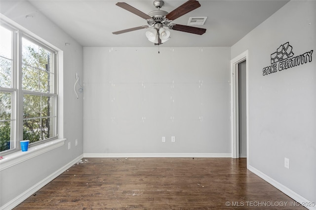 empty room featuring ceiling fan and dark hardwood / wood-style flooring