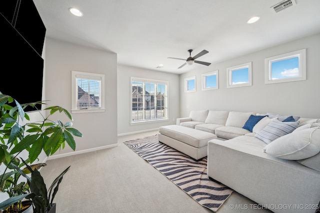 carpeted living room featuring ceiling fan