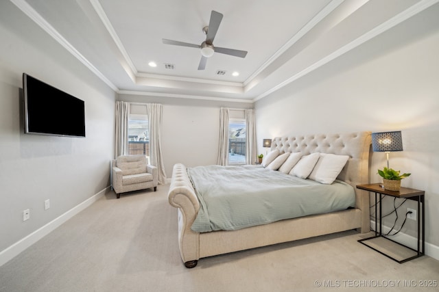 carpeted bedroom featuring a tray ceiling, ceiling fan, and ornamental molding