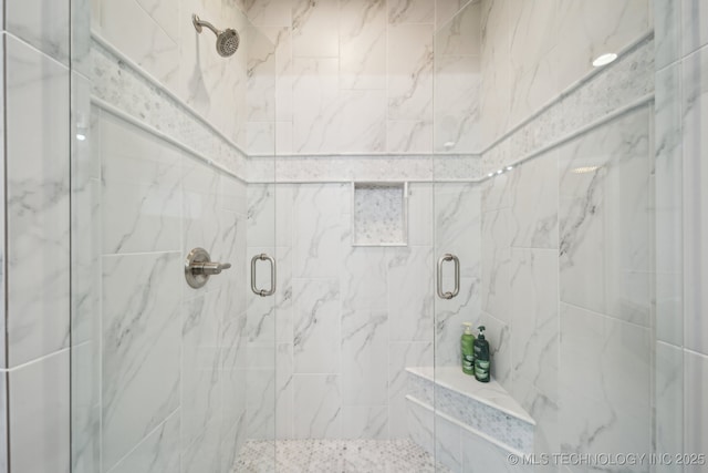 bathroom featuring a shower with door