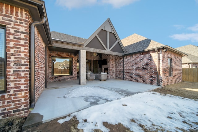 view of snow covered rear of property