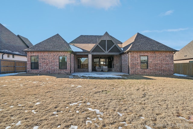 back of house with a lawn and a patio area