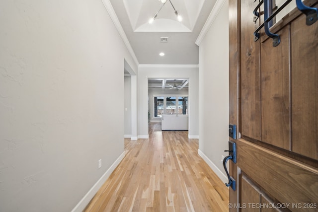 entryway featuring crown molding, ceiling fan, and light wood-type flooring