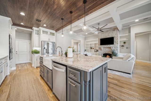 kitchen featuring built in shelves, hanging light fixtures, stainless steel appliances, gray cabinets, and white cabinets