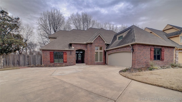 french country home featuring a garage