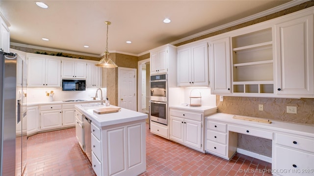 kitchen with black appliances, an island with sink, pendant lighting, white cabinets, and backsplash