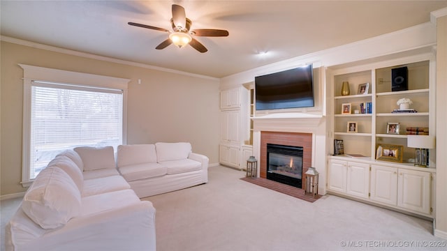 carpeted living room with a brick fireplace, ceiling fan, and ornamental molding