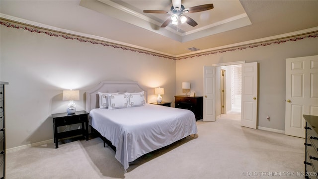 bedroom with ceiling fan, crown molding, a raised ceiling, and carpet floors