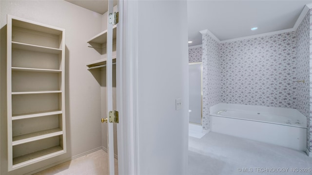 bathroom with a bath and crown molding