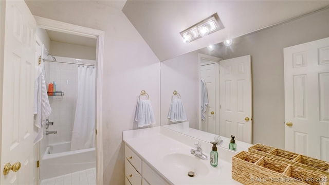 bathroom with shower / tub combo and vanity