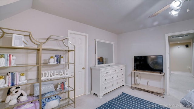 bedroom featuring light carpet, ceiling fan, and vaulted ceiling