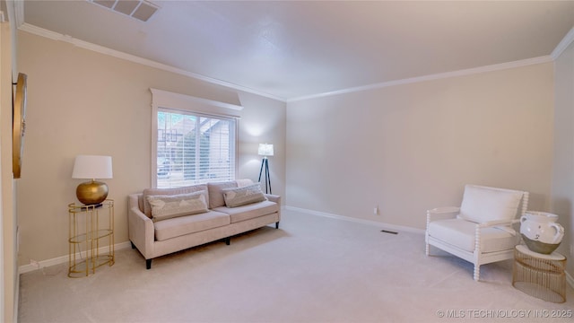 sitting room with crown molding and light colored carpet