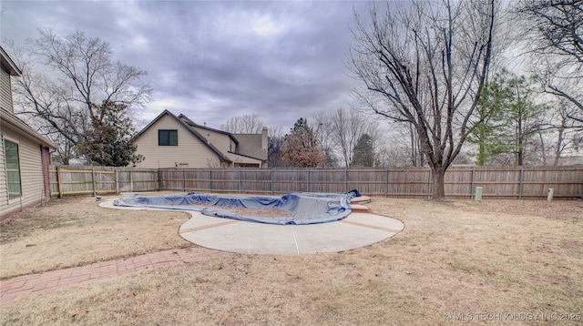 view of swimming pool with a yard and a patio