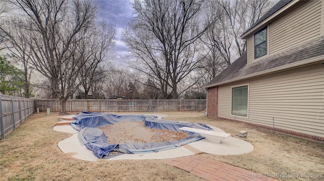 view of pool with a lawn