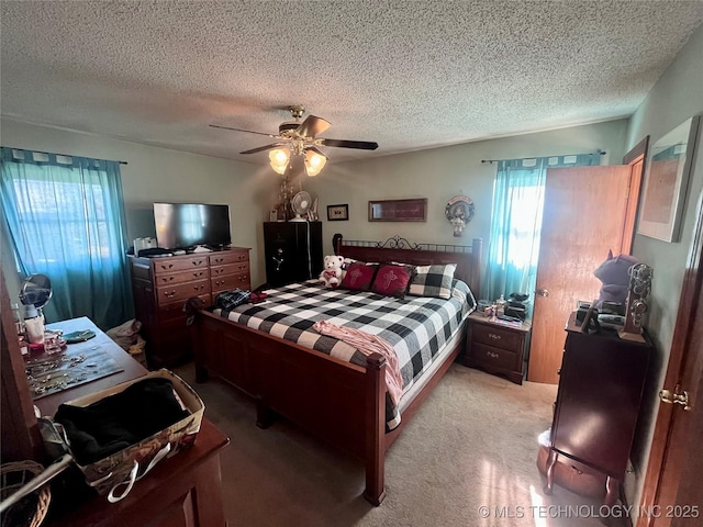 carpeted bedroom with a textured ceiling and ceiling fan