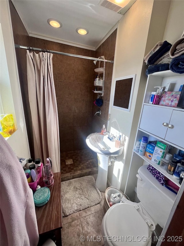 bathroom with toilet, tile patterned flooring, and a shower with shower curtain