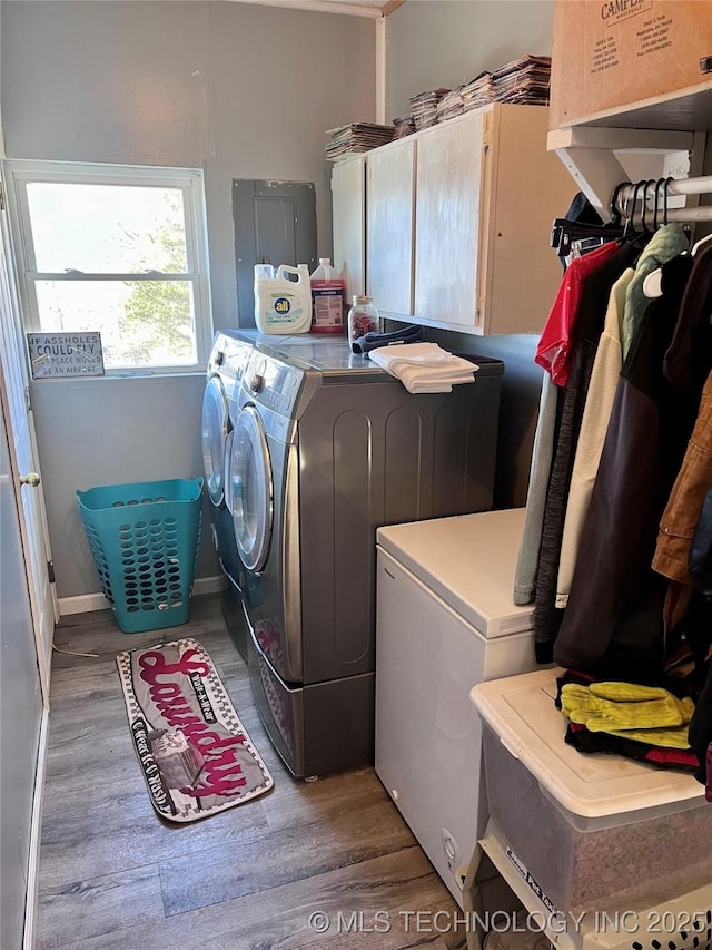 laundry area featuring cabinets, washer and dryer, and dark hardwood / wood-style floors