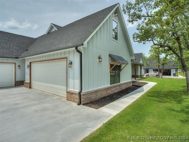 view of home's exterior with a lawn and a garage