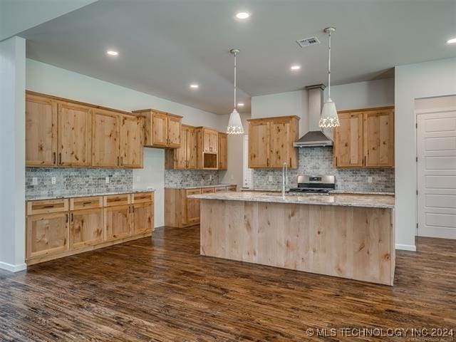 kitchen featuring wall chimney range hood, electric range, decorative light fixtures, a center island with sink, and dark hardwood / wood-style floors