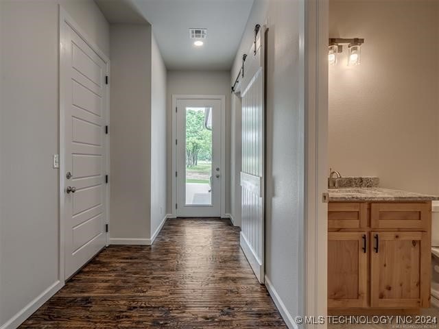 doorway with dark hardwood / wood-style floors