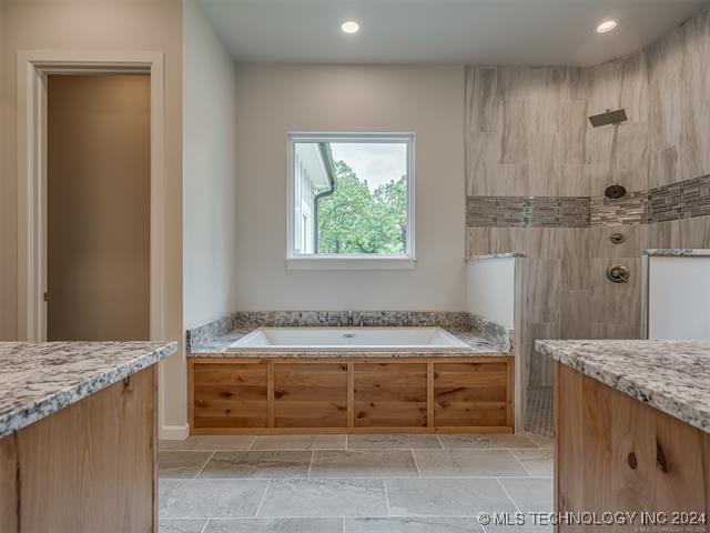 bathroom featuring plus walk in shower and vanity