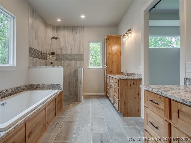 bathroom with separate shower and tub and vanity