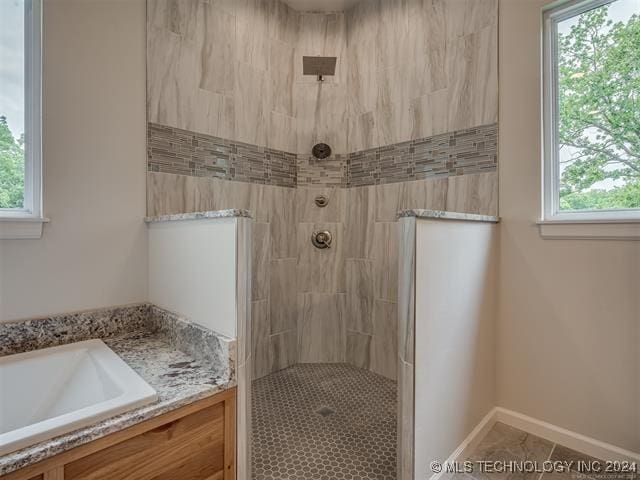 bathroom featuring tile patterned floors, sink, a healthy amount of sunlight, and shower with separate bathtub