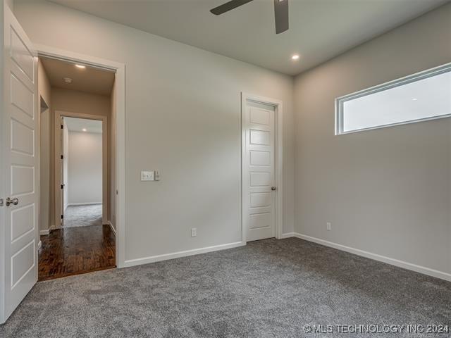 interior space featuring carpet flooring and ceiling fan