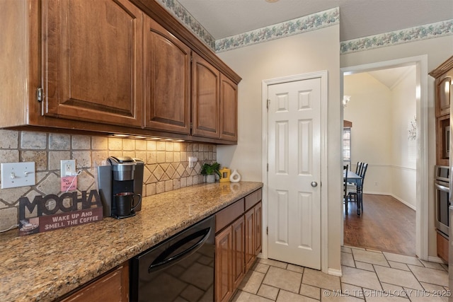 kitchen with dishwasher, backsplash, oven, light stone countertops, and light tile patterned floors