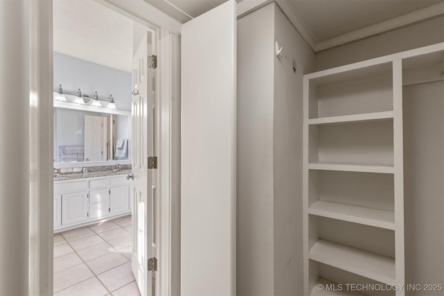 interior space with tile patterned floors, vanity, and ornamental molding