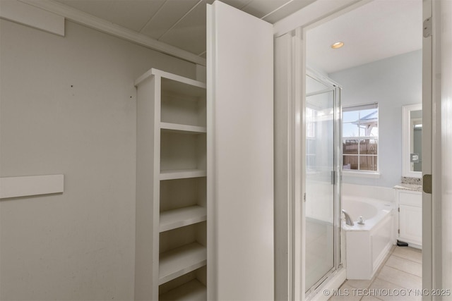 bathroom with tile patterned floors, vanity, separate shower and tub, and ornamental molding