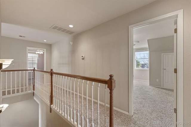 hallway featuring carpet and a healthy amount of sunlight