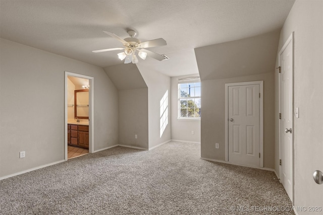 bonus room with light carpet, vaulted ceiling, and ceiling fan