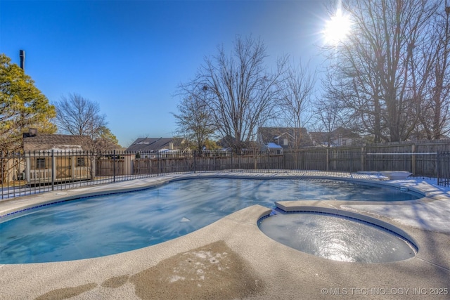 view of pool with an in ground hot tub