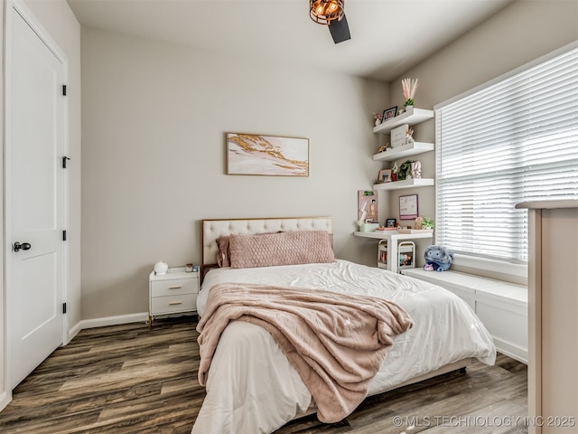 bedroom featuring ceiling fan and dark wood-type flooring